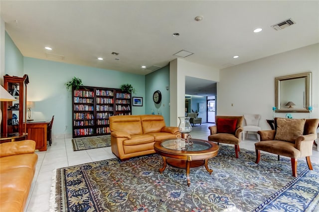 living room featuring light tile patterned flooring, visible vents, and recessed lighting