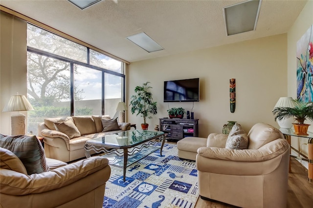 living area with a textured ceiling and wood finished floors