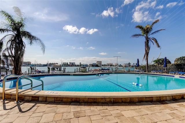 community pool featuring a dock and fence