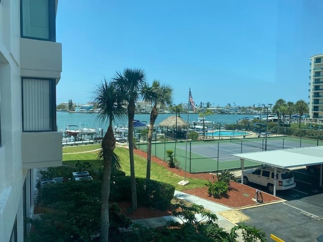 view of sport court featuring a water view