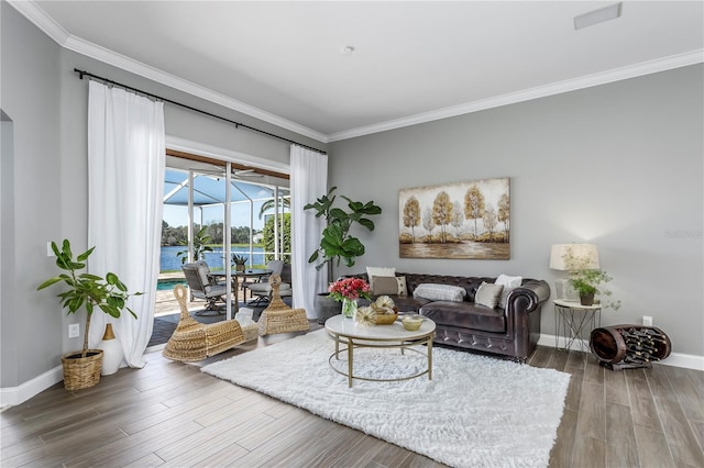 living area featuring a sunroom, crown molding, baseboards, and wood finished floors