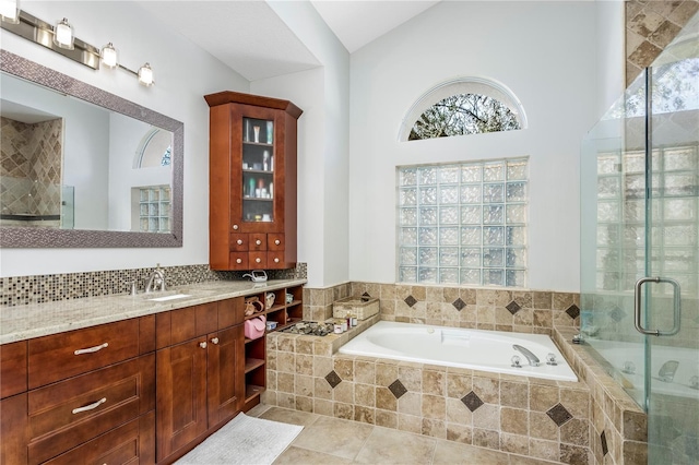 bathroom with a stall shower, tile patterned flooring, plenty of natural light, and a bath