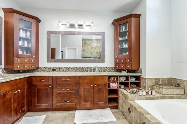 bathroom with double vanity, tile patterned floors, a tile shower, tiled tub, and a sink