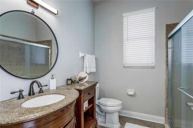 bathroom featuring toilet, a stall shower, baseboards, and vanity