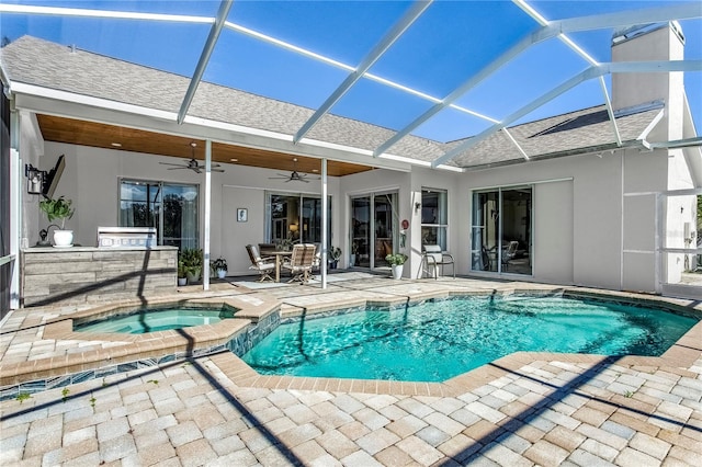 view of swimming pool with a ceiling fan, a pool with connected hot tub, a lanai, and a patio