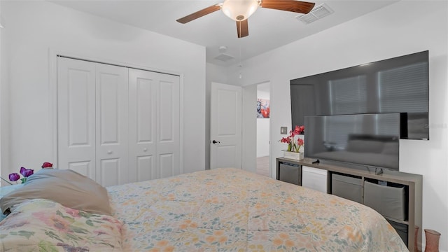 bedroom featuring a closet, visible vents, and ceiling fan