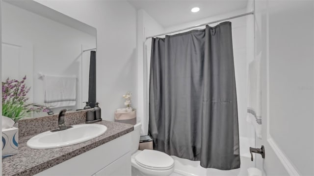 bathroom featuring toilet, vanity, and a shower with shower curtain