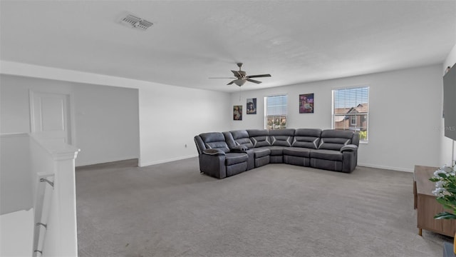 living area with carpet floors, visible vents, ceiling fan, and baseboards