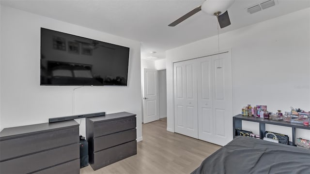 bedroom with a ceiling fan, light wood-type flooring, a closet, and visible vents