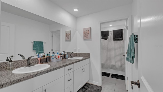 bathroom featuring tile patterned flooring, a sink, a shower with shower curtain, and double vanity