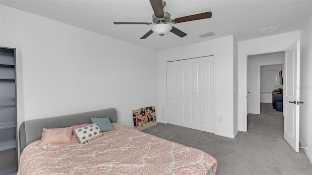 carpeted bedroom with a closet, visible vents, ceiling fan, and baseboards