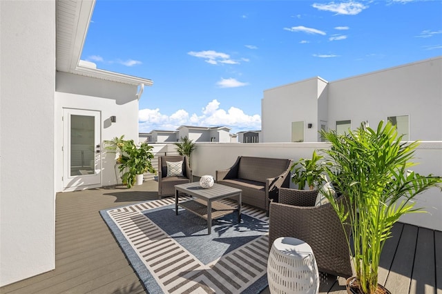 wooden terrace with an outdoor hangout area