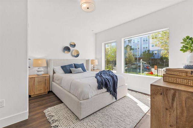 bedroom featuring wood finished floors and baseboards