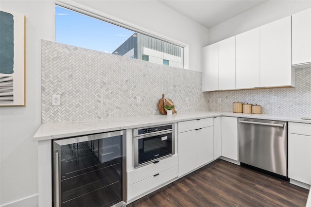 kitchen featuring wine cooler, dark wood-style flooring, decorative backsplash, stainless steel dishwasher, and white cabinetry