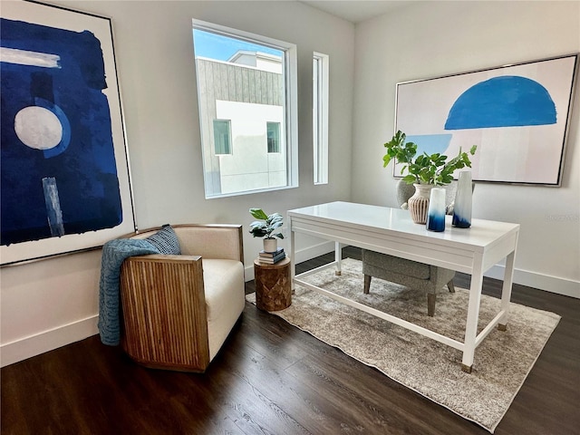 office space with baseboards and wood finished floors