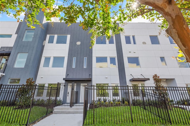 view of building exterior with a fenced front yard