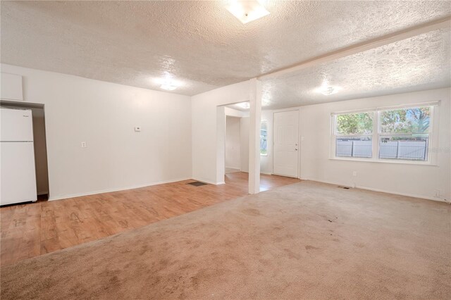 1800 27th Ave N, Saint Petersburg, FL 33713 - carpeted empty room with visible vents, a textured ceiling, and baseboards
