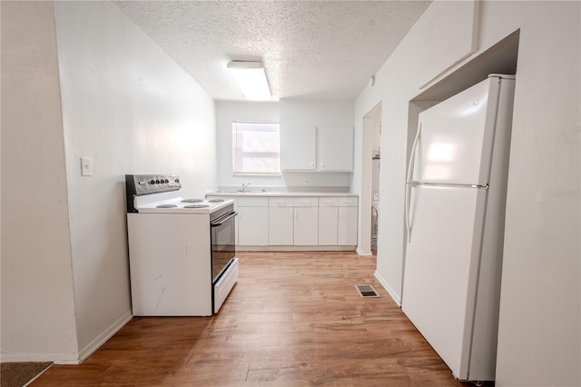 1800 27th Ave N, Saint Petersburg, FL 33713 - kitchen featuring a textured ceiling, white appliances, a sink, white cabinetry, and light wood finished floors