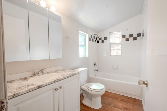 1800 27th Ave N, Saint Petersburg, FL 33713 - full bathroom with lofted ceiling, toilet, wood finished floors, vanity, and shower / washtub combination
