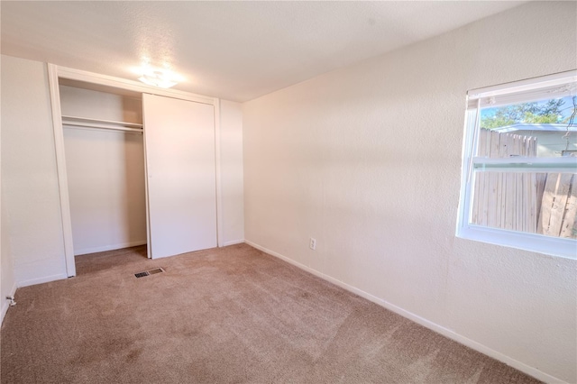 1800 27th Ave N, Saint Petersburg, FL 33713 - unfurnished bedroom featuring a closet, visible vents, and carpet flooring