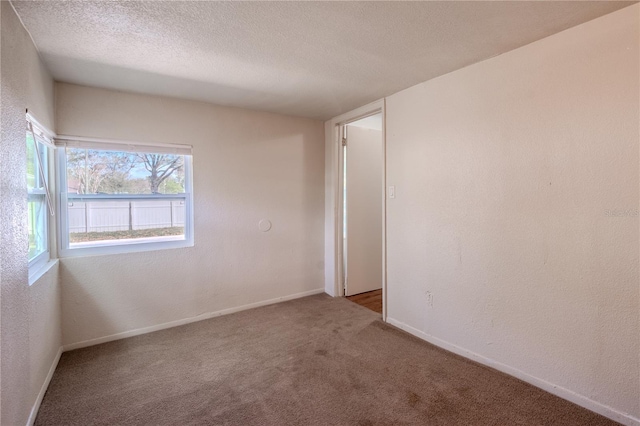 1800 27th Ave N, Saint Petersburg, FL 33713 - unfurnished room with carpet, baseboards, a textured ceiling, and a textured wall