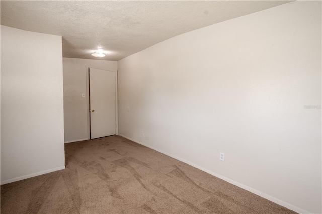 1800 27th Ave N, Saint Petersburg, FL 33713 - spare room with carpet flooring, a textured ceiling, and baseboards