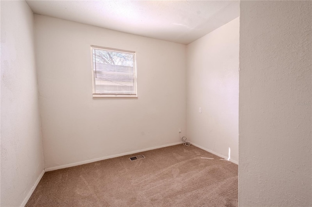 1800 27th Ave N, Saint Petersburg, FL 33713 - spare room featuring carpet floors, visible vents, a textured wall, and baseboards