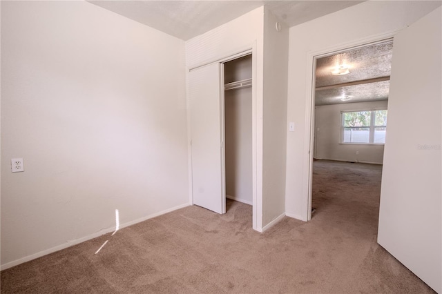 1800 27th Ave N, Saint Petersburg, FL 33713 - unfurnished bedroom with a closet, light carpet, and baseboards