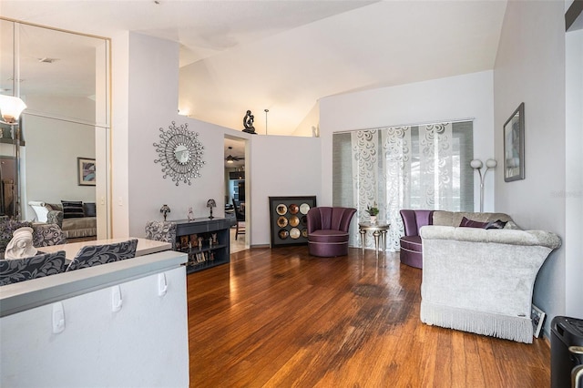 living room with lofted ceiling and wood finished floors