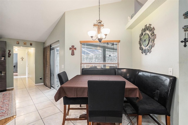 dining space with vaulted ceiling, light tile patterned floors, baseboards, and an inviting chandelier