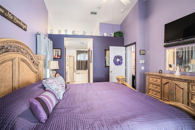 bedroom with high vaulted ceiling, ensuite bath, visible vents, and a ceiling fan