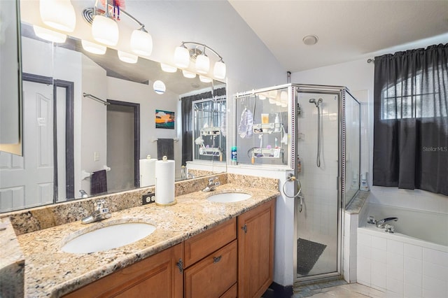 full bathroom with a garden tub, a shower stall, and a sink