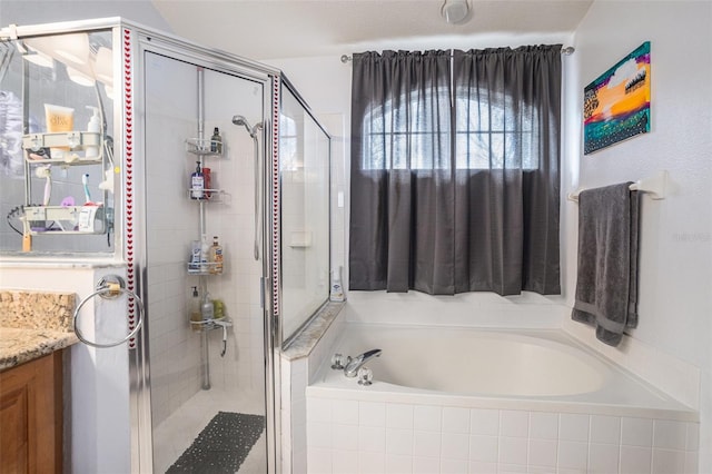 bathroom featuring a stall shower, vanity, and a bath