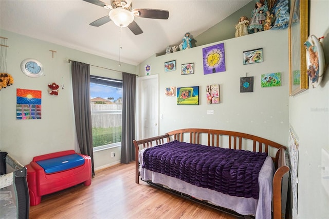 bedroom featuring lofted ceiling, ceiling fan, baseboards, and wood finished floors