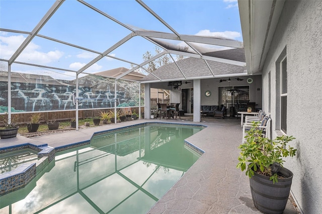 view of swimming pool with a patio, ceiling fan, a lanai, outdoor dining area, and a pool with connected hot tub