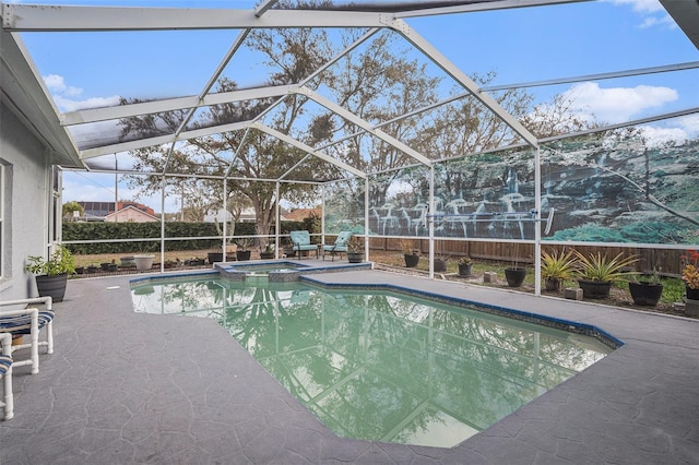 view of pool with a pool with connected hot tub, a patio, a lanai, and fence