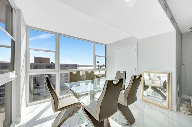 dining area featuring marble finish floor