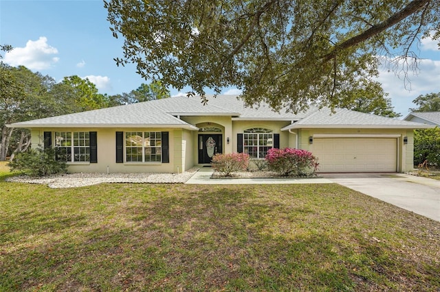 ranch-style home with a front lawn, concrete driveway, roof with shingles, and an attached garage