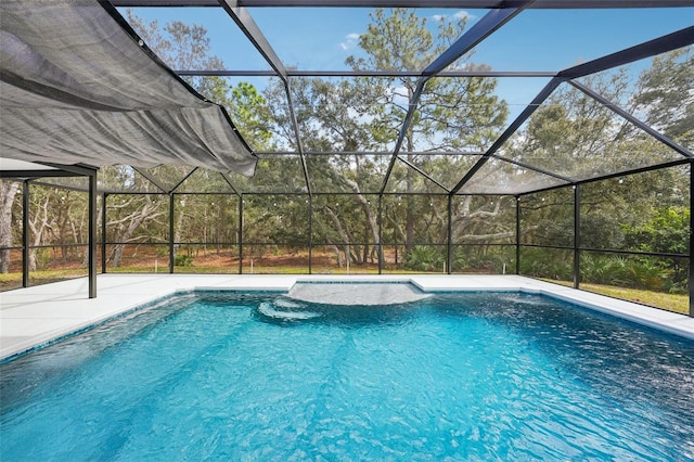 pool featuring a patio area and glass enclosure