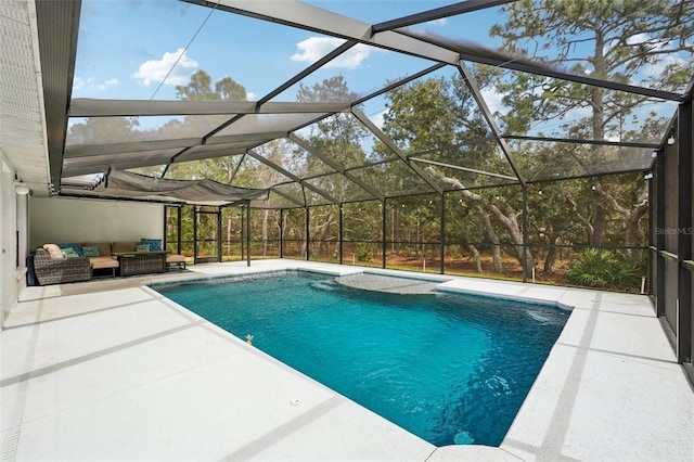 outdoor pool with glass enclosure, a patio area, and an outdoor hangout area