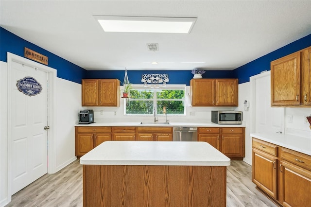 kitchen featuring light countertops, appliances with stainless steel finishes, visible vents, and light wood-style floors