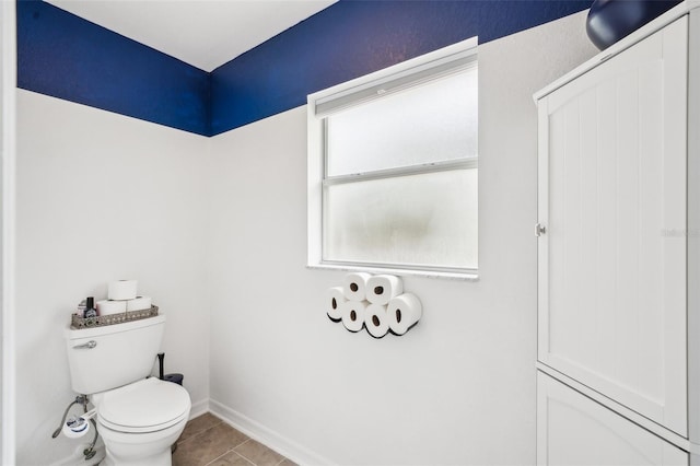 bathroom featuring baseboards, toilet, and tile patterned floors