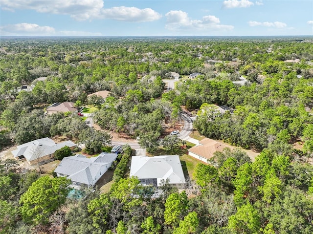 bird's eye view featuring a wooded view and a residential view