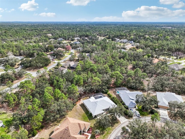 drone / aerial view with a residential view and a view of trees