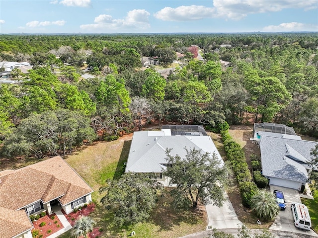 birds eye view of property with a wooded view