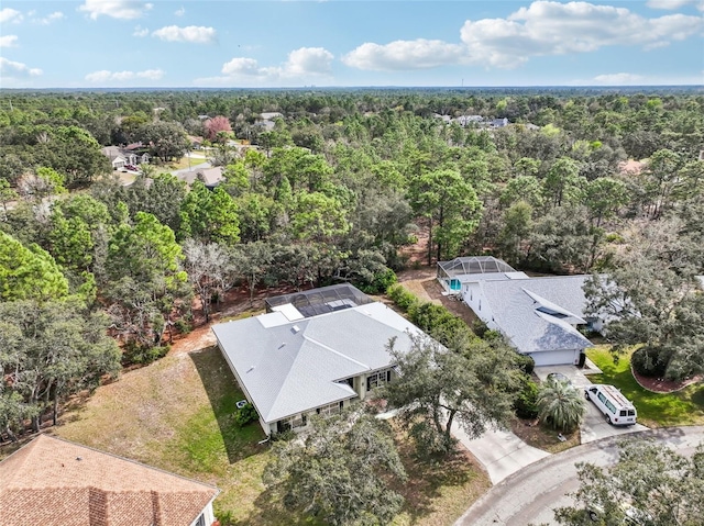 drone / aerial view with a wooded view