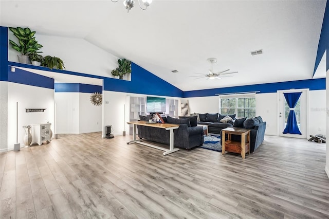 living room featuring a ceiling fan, visible vents, and wood finished floors