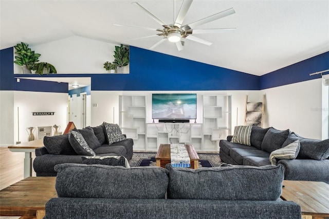 living area with a ceiling fan, vaulted ceiling, and wood finished floors