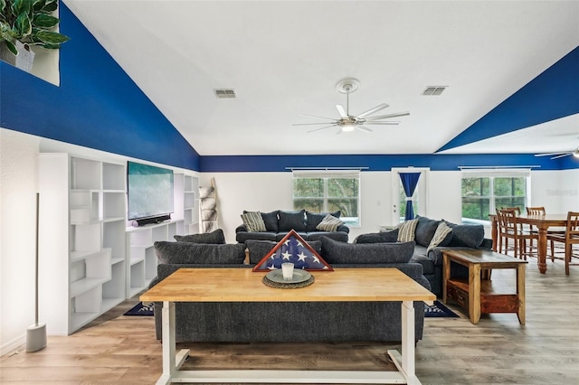 living area featuring plenty of natural light, ceiling fan, visible vents, and vaulted ceiling