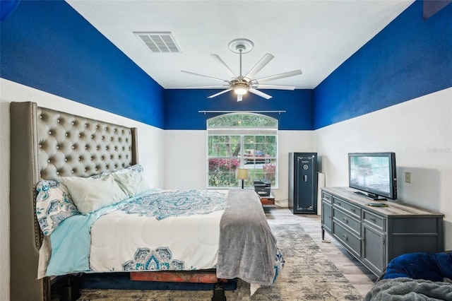 bedroom featuring ceiling fan, visible vents, and light wood-style floors